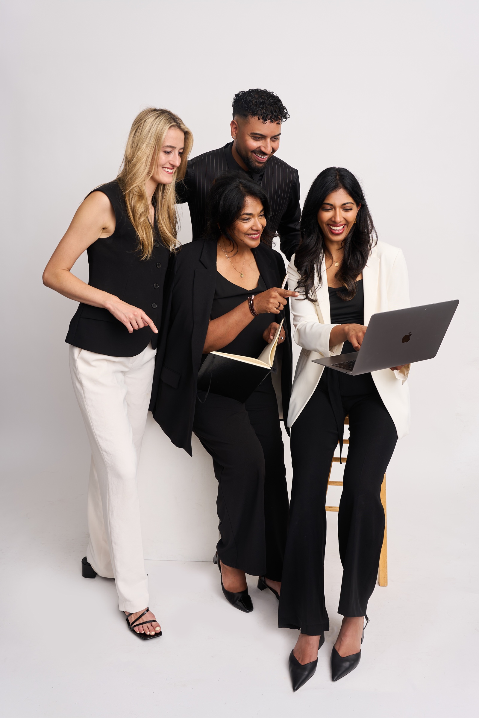 The Visionary Events team collaborating around a laptop